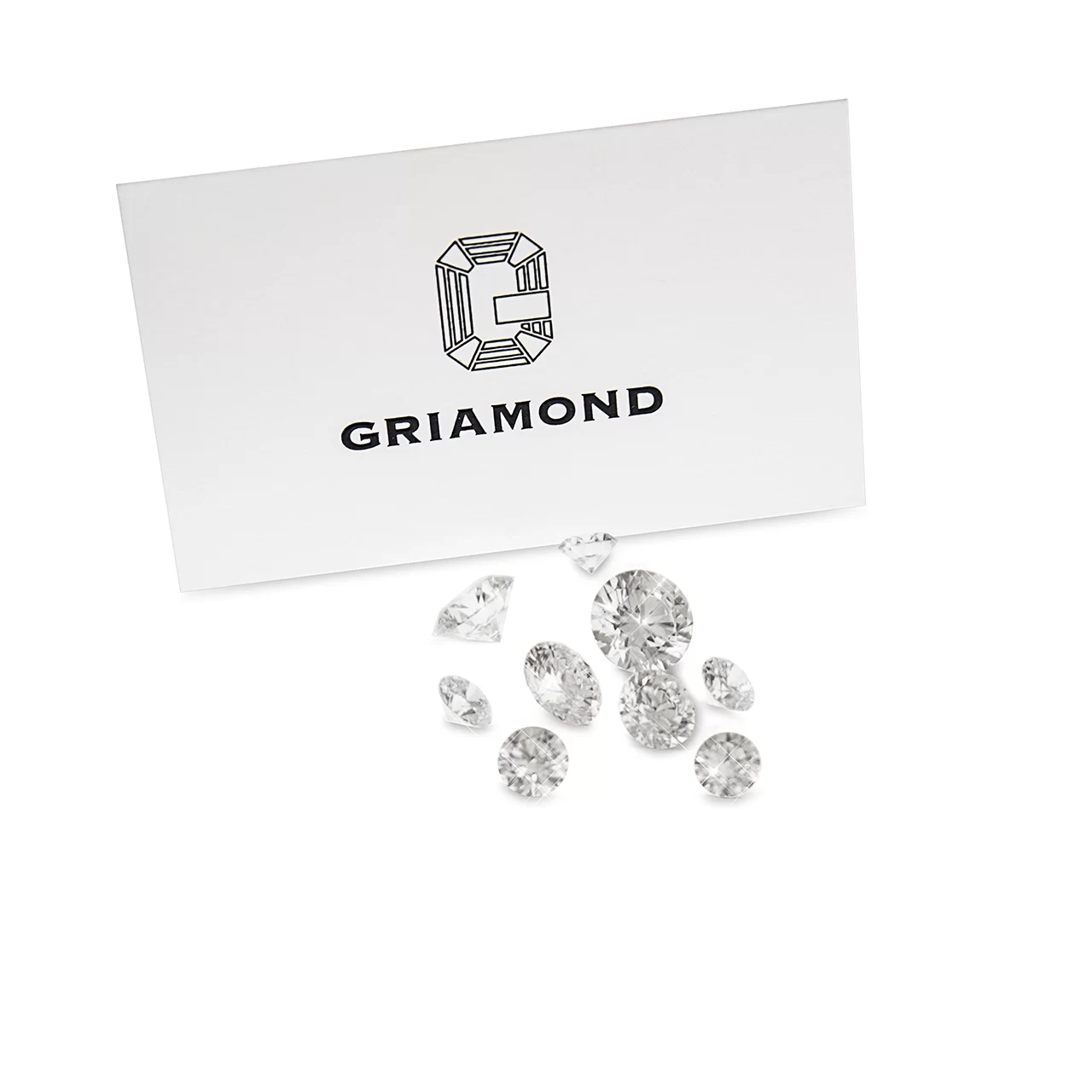a white card that reads griamond and their logo and in front of the card are a handful of various size diamonds