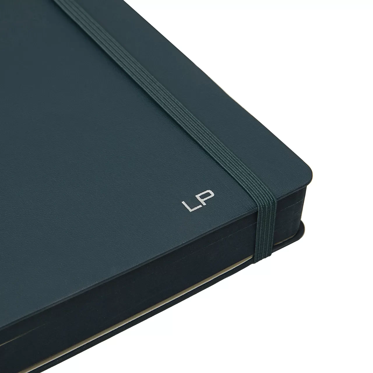 a close up of a black notebook with a band and with thwo silver uppercase letters