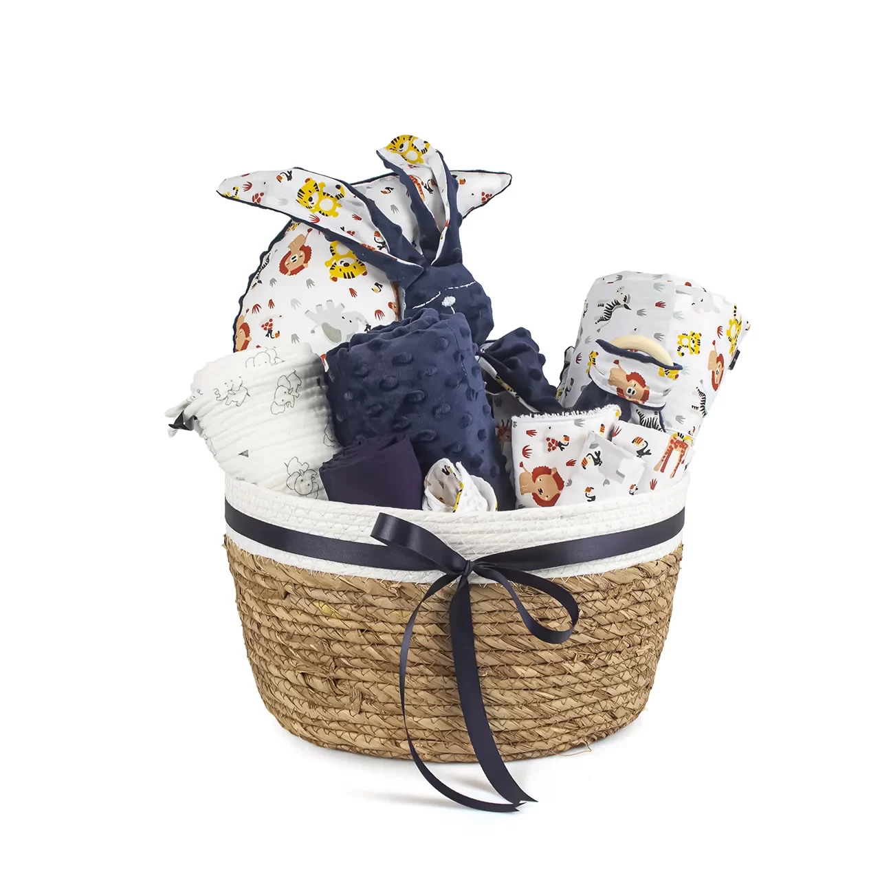 rope gift basket with a blue bow that inside of it has a blue cloth bunny and a blue blanket and with sheets with animal pattern and a half moon white with animal pattern pillow