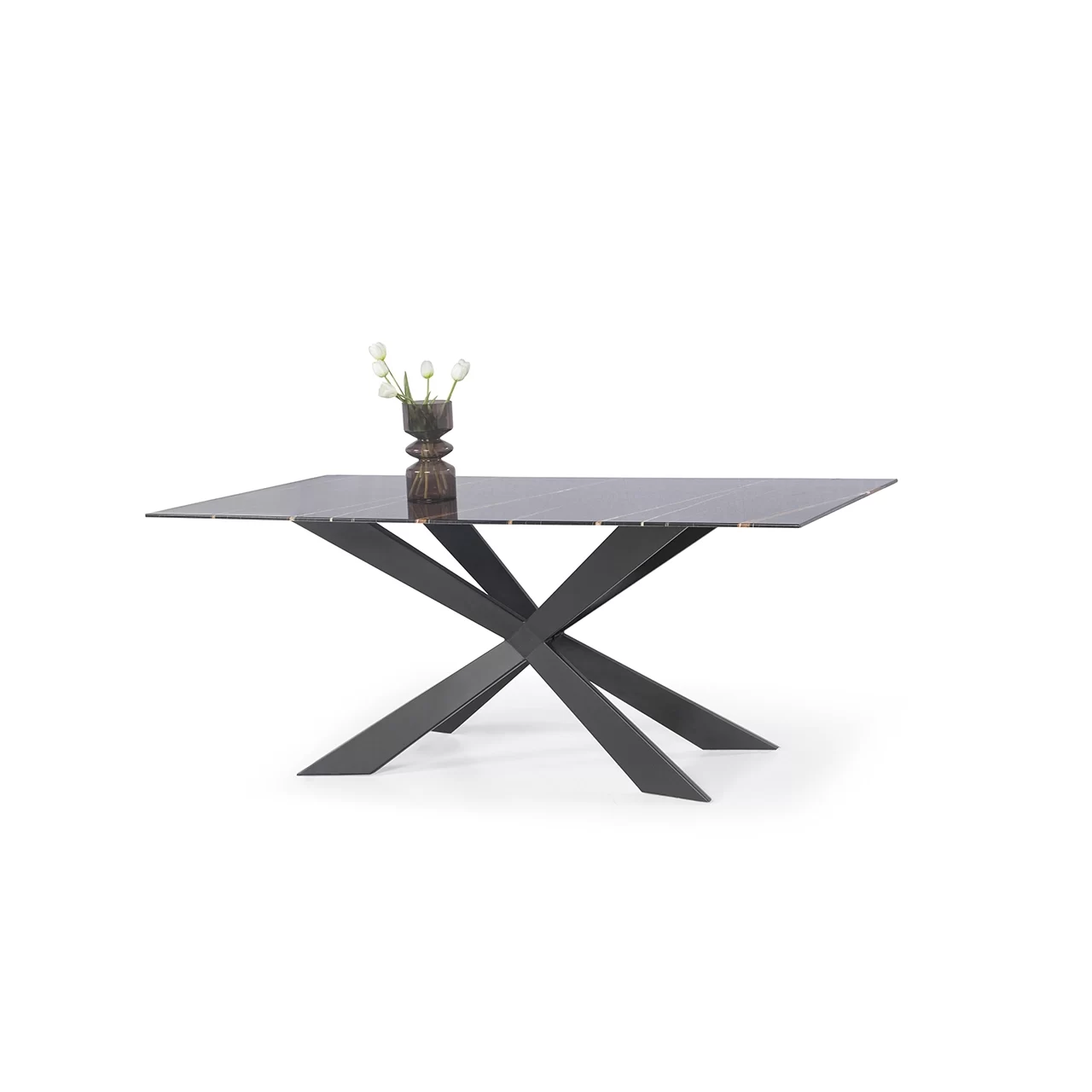 a black glass table with legs that are an x and a plant ot top of the table